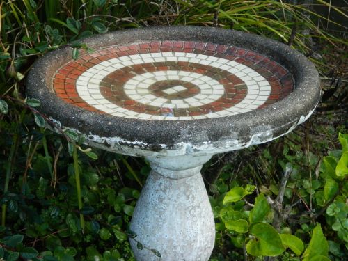 Pedestal bird bath with decorations